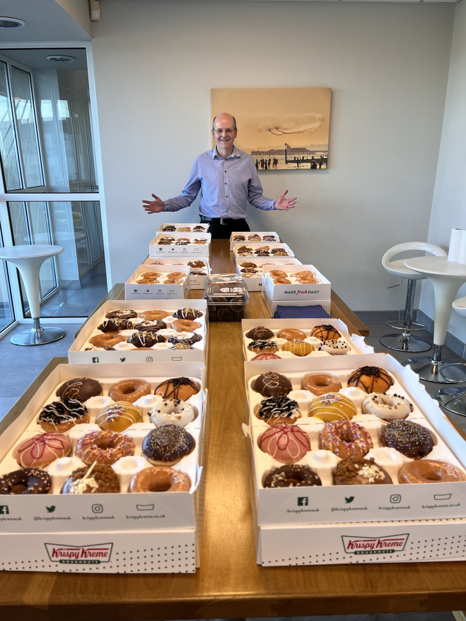Man with multiple boxes of donuts