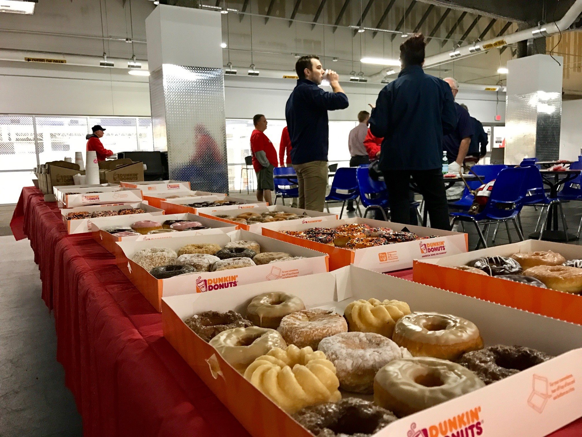 Many boxes of donuts on a table